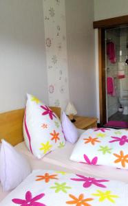 a bedroom with two beds with flowers on them at Blütenhotel Village in Sarnau
