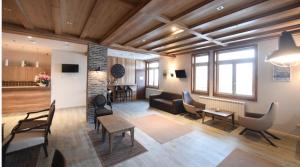 a living room with a couch and a table and chairs at IN Apartman, Župa Kopaonik in Kopaonik