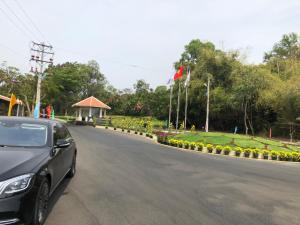 a car driving down a road with a garden at LuxSea Villa in Phan Thiet