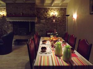 a dining room with a table with food on it at Chez Lili in Izé