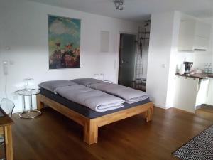 a bed sitting in a living room with at Ferienwohnung im Weinbergweg in Ravensburg