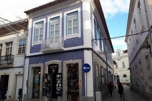 un bâtiment bleu et blanc sur le côté d'une rue dans l'établissement Ficus Áurea, à Aveiro