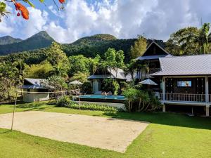 a house with a pool and mountains in the background at villa inspiration in Ko Chang