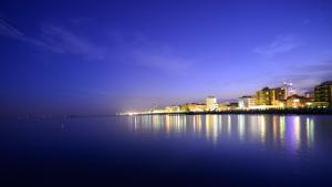 a night view of a city with lights on the water at Agriturismo La Barena in Jesolo