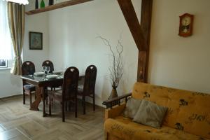 a living room with a table and a couch at Apartment House Maestro Teplice in Teplice