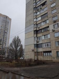an old apartment building next to a tall building at Стильные аппартаменты на Новых Домах in Kharkiv