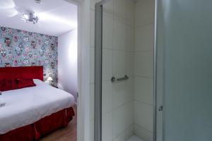 
a bedroom with a white bed and white walls at Hotel Onderbergen in Ghent
