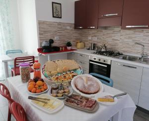 a kitchen with a table with food on it at B&B EDEN OGLIASTRA in Tortolì