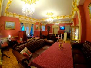 a living room with leather couches and a table at Hotel Lavilia in Kyiv