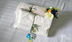 two towels with flowers on them on a bed at Kwetu Home - Sagana PAY BEFORE ARRIVAL in Sagana