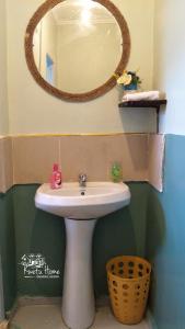 a bathroom with a white sink and a mirror at Kwetu Home - Sagana PAY BEFORE ARRIVAL in Sagana