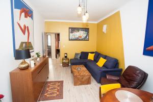 a living room with a blue couch and a table at Apartament Golden in Mielec