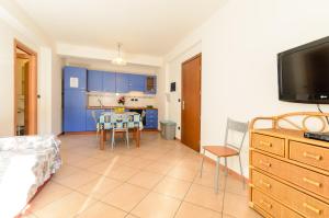 a living room with a kitchen and a dining room at Le Tartarughe Aparthotel in Letojanni