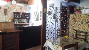 a dining room with a glass table and a bar at Pousada Luar e Serenata in Conservatória