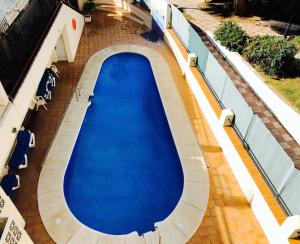 an overhead view of a large blue swimming pool at Beach Front Apartment-1st Line in Marbella