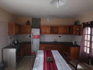 a kitchen with wooden cabinets and a white refrigerator at ND nuestro destino in Cafayate