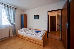 Ένα ή περισσότερα κρεβάτια σε δωμάτιο στο Penzion Zajíček