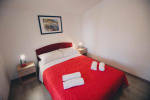 A bed or beds in a room at Apartments Vodice