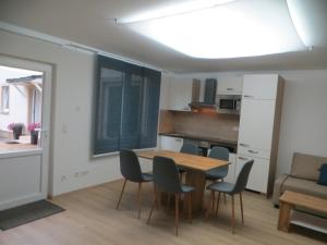 a kitchen and dining room with a table and chairs at Premium City Apartment Amadeus in Salzburg +10 photos