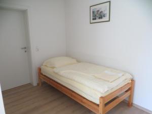a small bed in a corner of a room at Premium City Apartment Amadeus in Salzburg