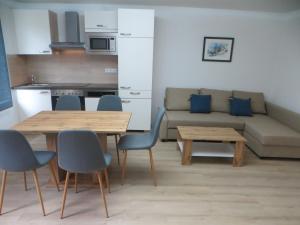 a living room with a couch and a table and chairs at Premium City Apartment Amadeus in Salzburg