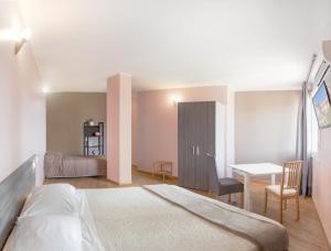 a bedroom with a bed and a desk and a table at Al Borgo in Sarzana