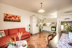 a living room with a red couch and a kitchen at Villa Antonella in Sorrento +17 photos