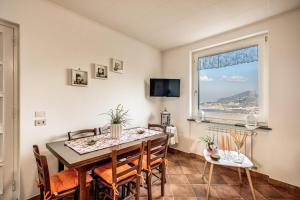 a dining room with a table and chairs and a window at Villa Antonella in Sorrento