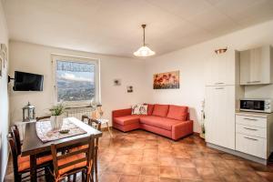a living room with a red couch and a table at Villa Antonella in Sorrento