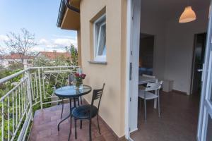 a balcony with a table and chairs and a table at Apartments Laura in Krk