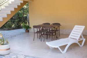 a patio with chairs and a table and stairs at Apartments Laura in Krk