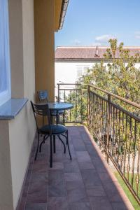 a patio with a table and chairs on a balcony at Apartments Laura in Krk