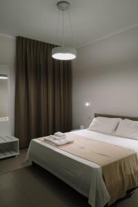 a bedroom with a large bed and a light at MaisonMe in Vasto