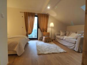 a bedroom with two beds and a large window at Guest house Sara Latin in Latin