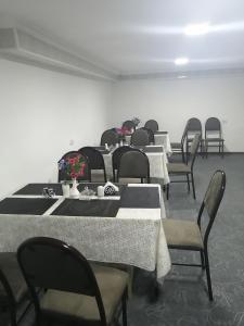 a row of tables and chairs in a room at Aziz Hotel in Samarkand