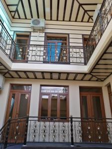 een gebouw met 2 balkons en een trap bij Aziz Hotel in Samarkand