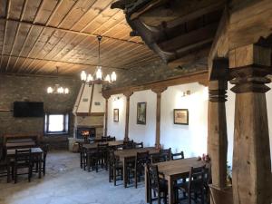 a dining room with tables and chairs in a building at Пачаловата къща in Kovačevica