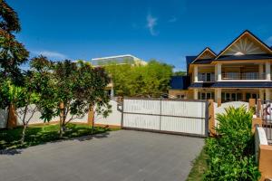 a house with a white fence and a driveway at Platinum Residence Villa in Rawai Beach