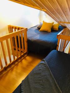 a bedroom with two beds and a stairway with a bed sqor at Levi Moonlight 214 in Kittilä