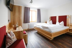 a hotel room with a bed and a couch at Landgasthof Geser in Sarching +28 photos