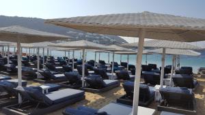 a bunch of chairs and umbrellas on a beach at Blue Heart Mykonos Up to 10 People Best Location in Mikonos