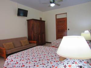 Postel nebo postele na pokoji v ubytování Hotel La Guaria Inn & Suites