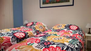 a bed with a colorful comforter and pillows on it at On the sea in Santa Marinella +63 photos
