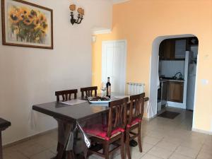 a dining room table with chairs and a bottle of wine at On the sea in Santa Marinella