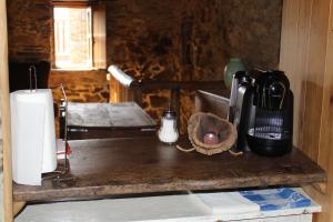 a kitchen counter with a coffee maker on top of it at Casa da Carvalha in Lousã