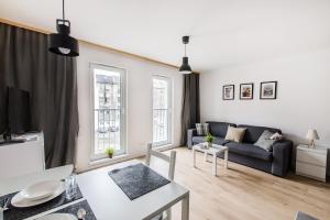 a living room with a couch and a table at Smart Rental Management Apartments in Wrocław