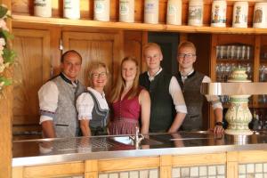 a group of people posing for a picture in a bar at Landgasthof Geser in Sarching