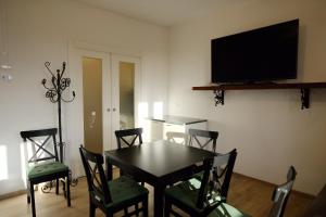 jadalnia ze stołem i krzesłami oraz telewizorem z płaskim ekranem w obiekcie Il Brigantino w mieście Cori