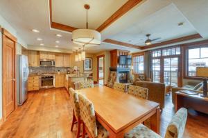 a kitchen and dining room with a wooden table and chairs at Luxury Ski Hill Condos in Breckenridge