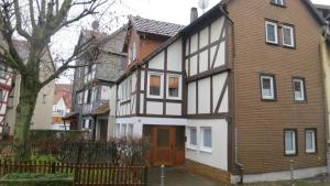a white and brown house with a wooden door at Alsfelder Apartment in Alsfeld